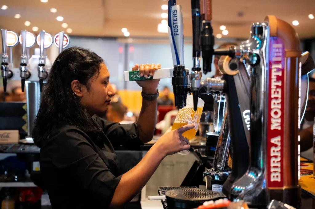 Bartender pulling a draught beer at Dawat Bar and Kitchen