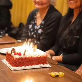 Birthday cake with candles at a party table at Dawat Bar and Kitchen
