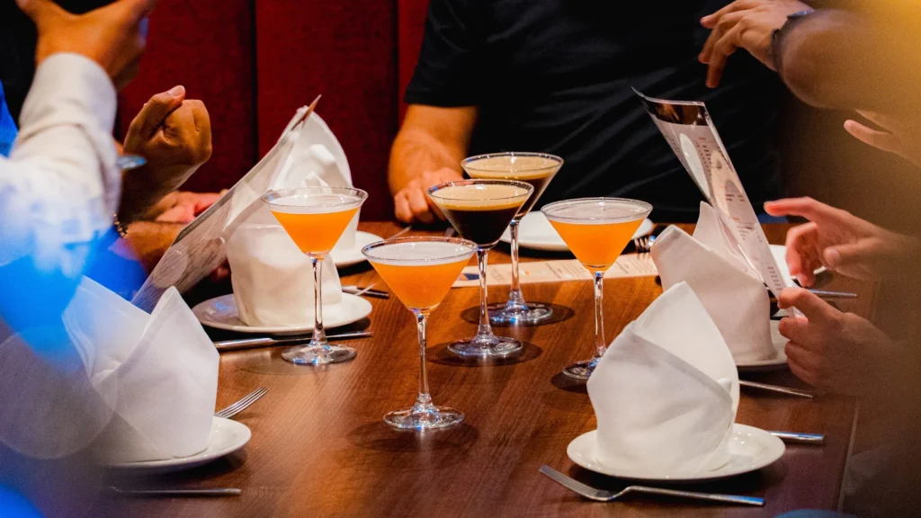 Cocktails being served to a group table at Dawat Bar and Kitchen