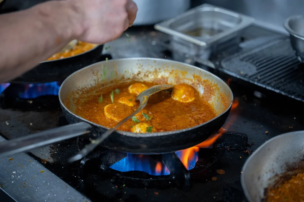Curry cooking over the flame in the Dawat Bar and Kitchen kitchen