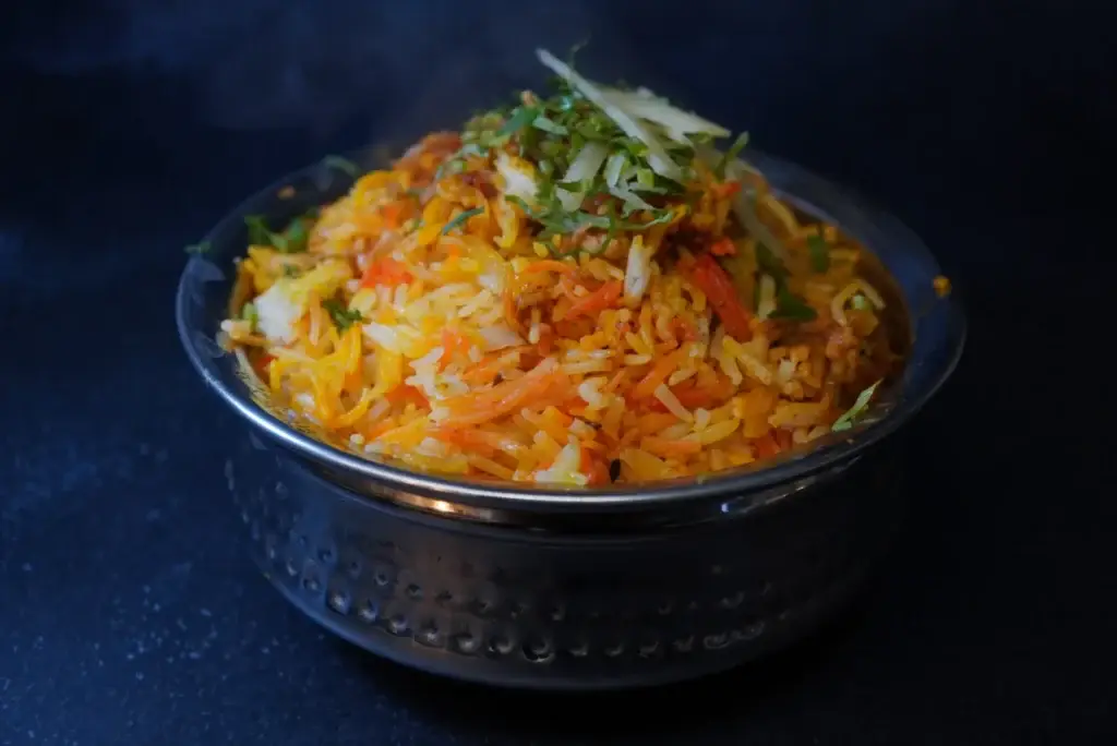 Dum ki biryani served in a copper handi at Dawat Bar and Kitchen