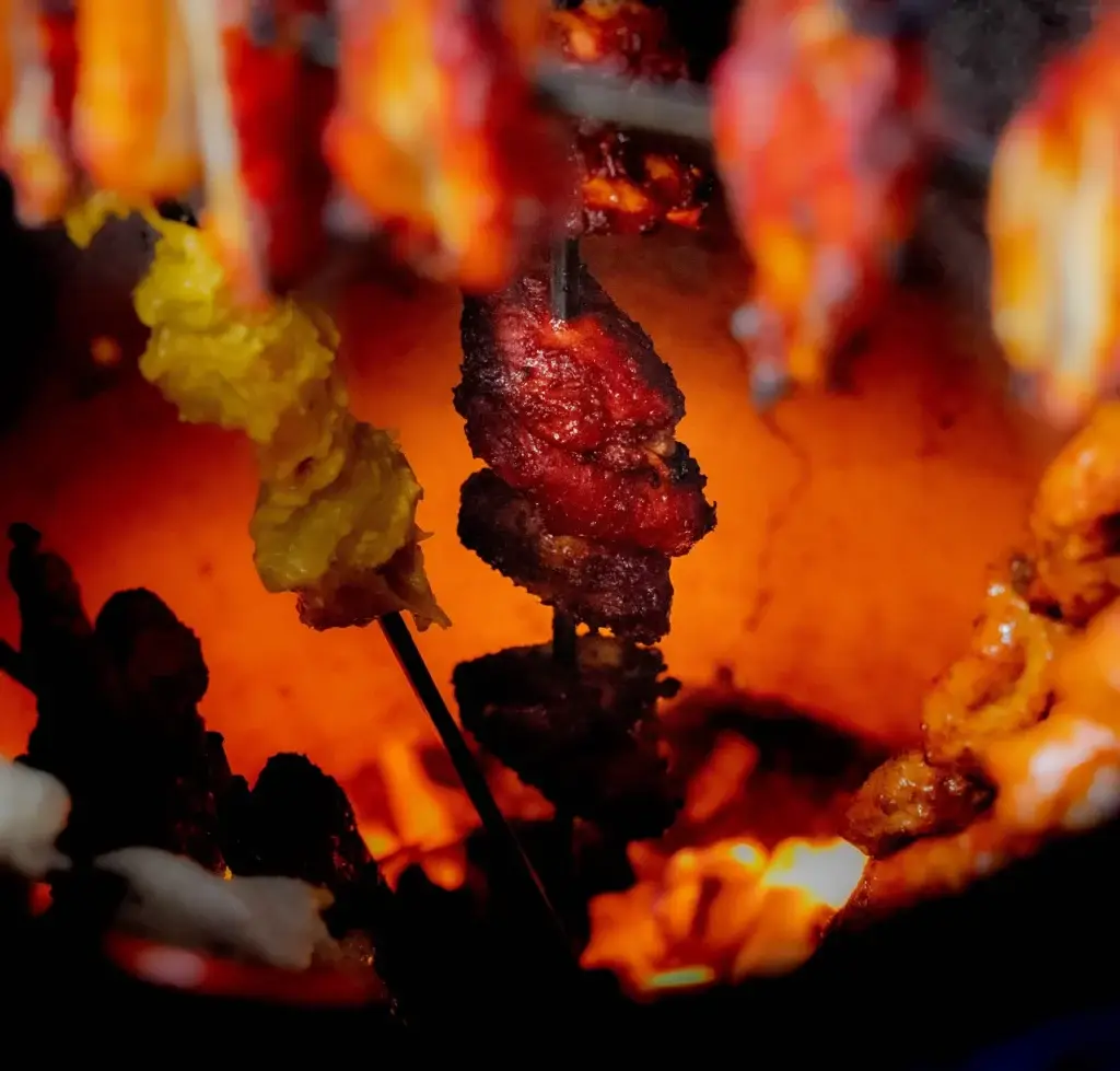 Kebabs over the coals in the tandoor at Dawat Bar and Kitchen