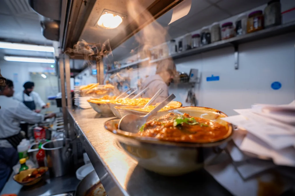 Dishes ready on the kitchen pass at Dawat Bar and Kitchen
