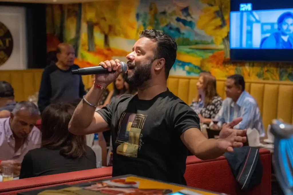 Live Bollywood singer performing to a full room at Dawat Bar and Kitchen, Queensbury