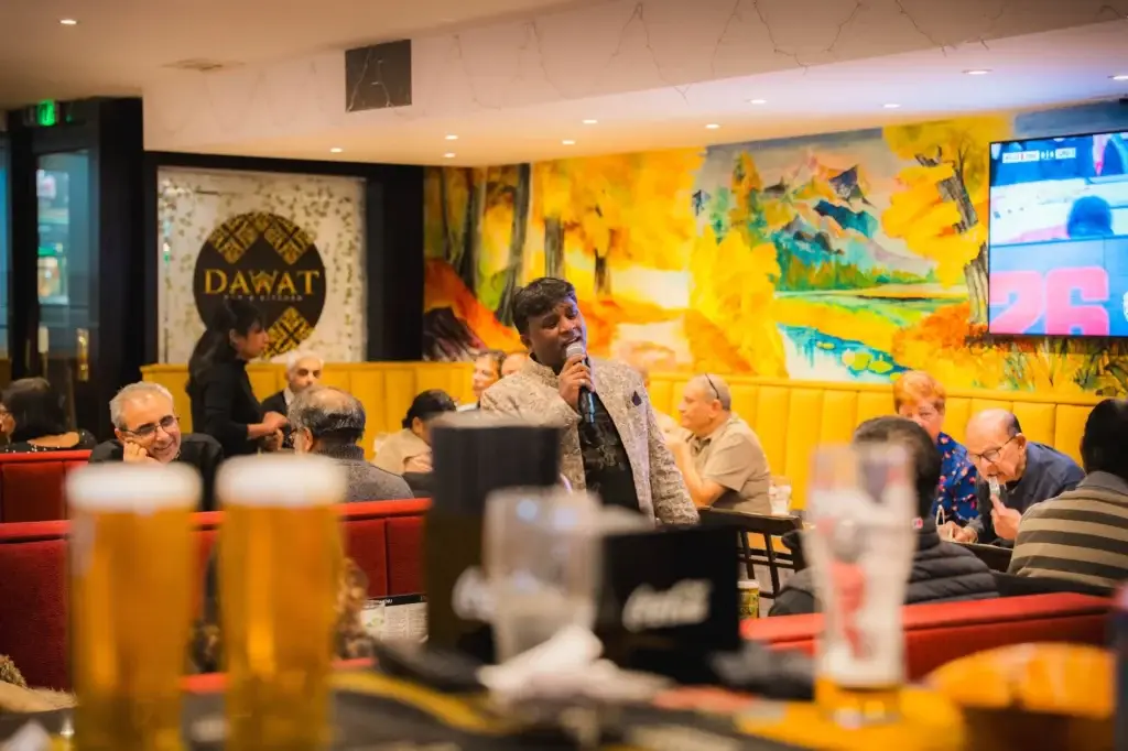 Live music seen from the bar, with pints in the foreground, at Dawat Bar and Kitchen