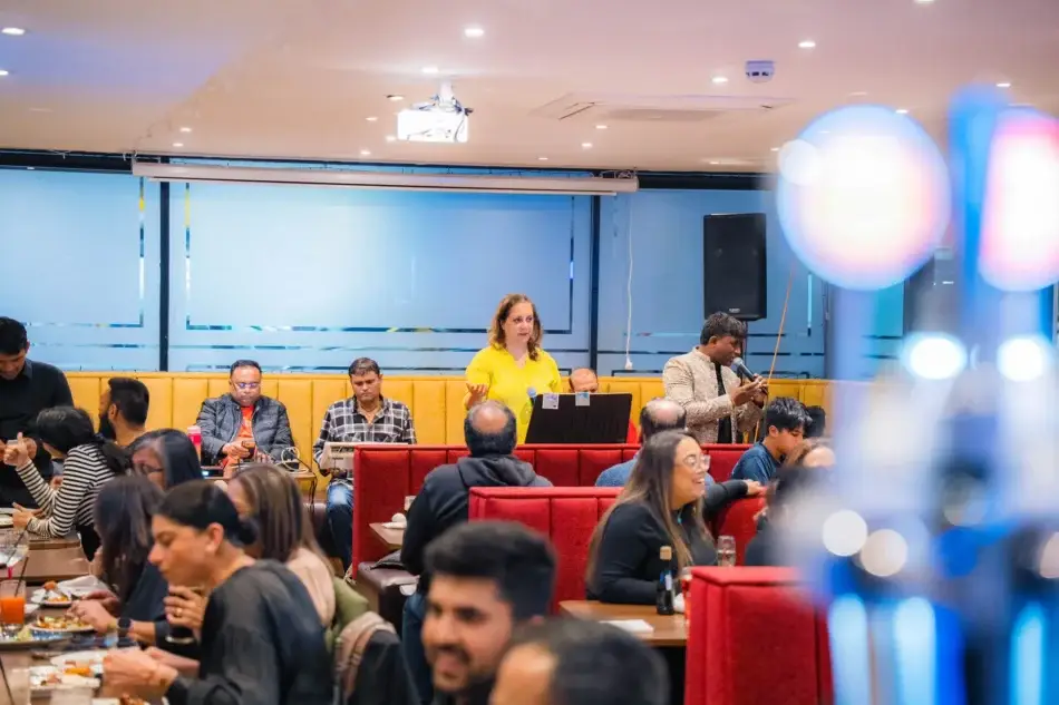 A Bollywood singer performing to a full dining room at Dawat Bar and Kitchen