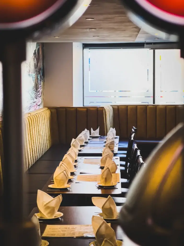 Long table laid with folded napkins for a private event at Dawat