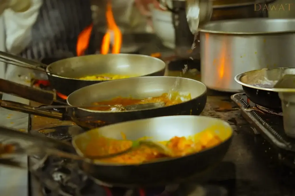 Pans of curry on the stove at Dawat Bar and Kitchen