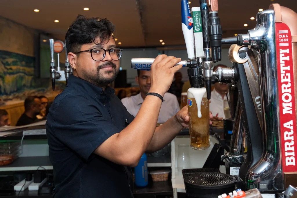 Bartender pouring a pint at Dawat Bar and Kitchen