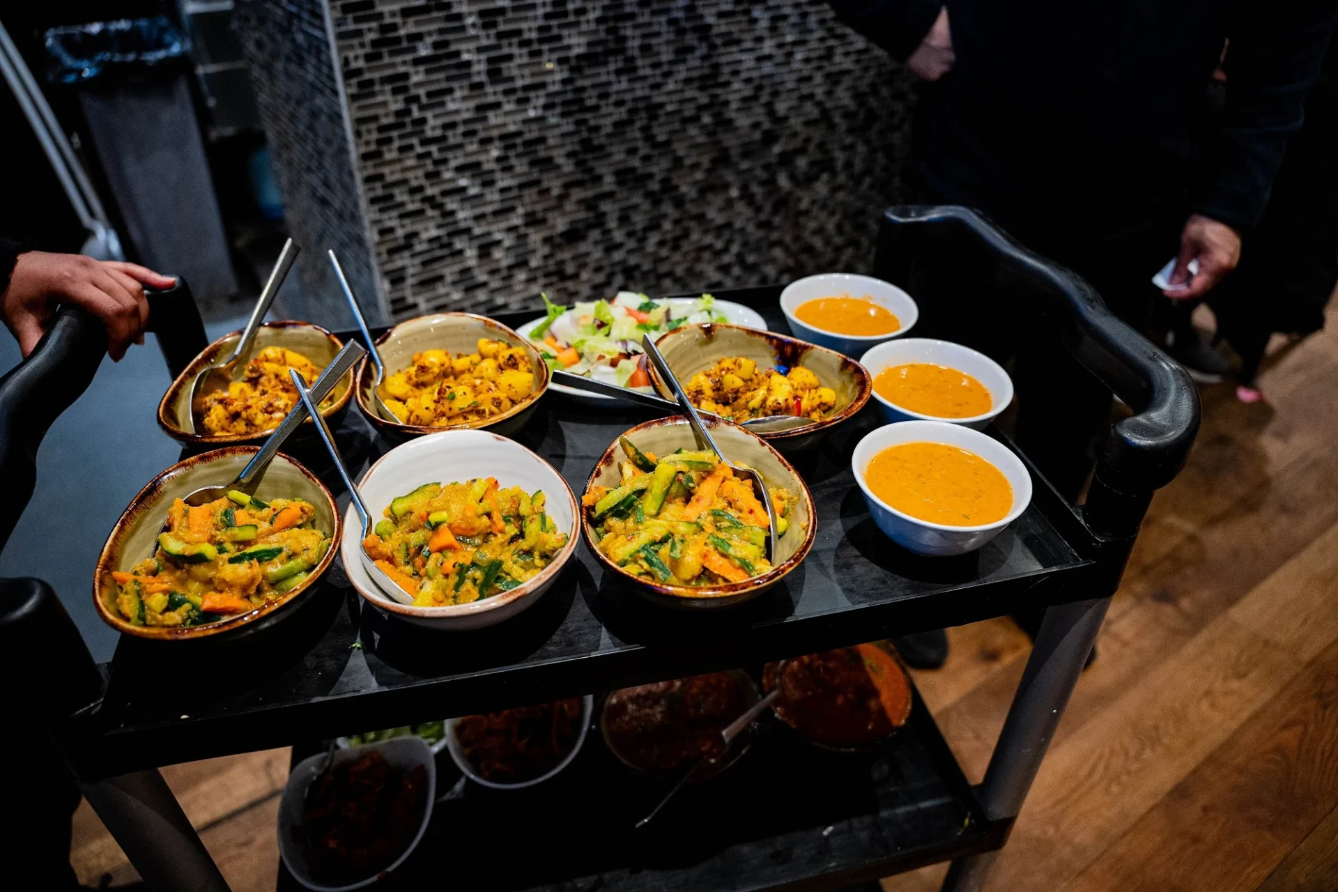 Sharing dishes on the serving trolley at Dawat Bar and Kitchen